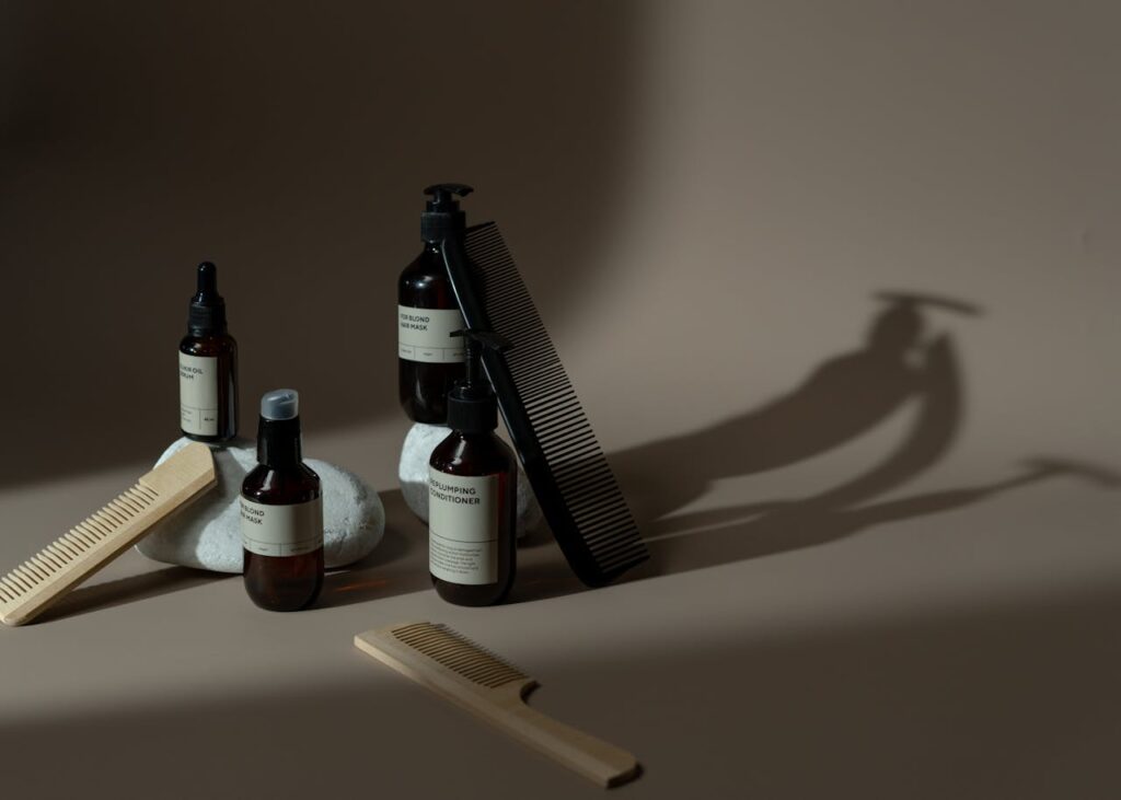 pexels-photo-7428097 Minimalist display of beauty products, combs, and natural elements on a neutral background.